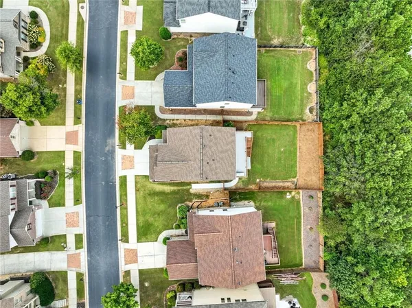 an aerial view of a house with a yard fountain and large tree
