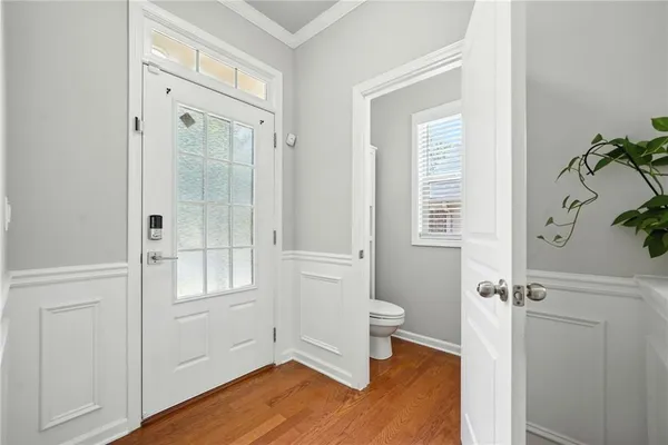 an empty room with wooden floor and a window