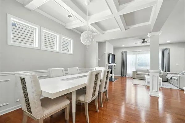 a view of a dining room with furniture wooden floor and a chandelier