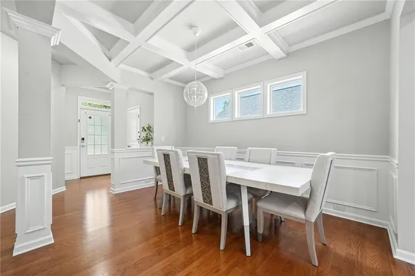 a view of a dining room with furniture and wooden floor