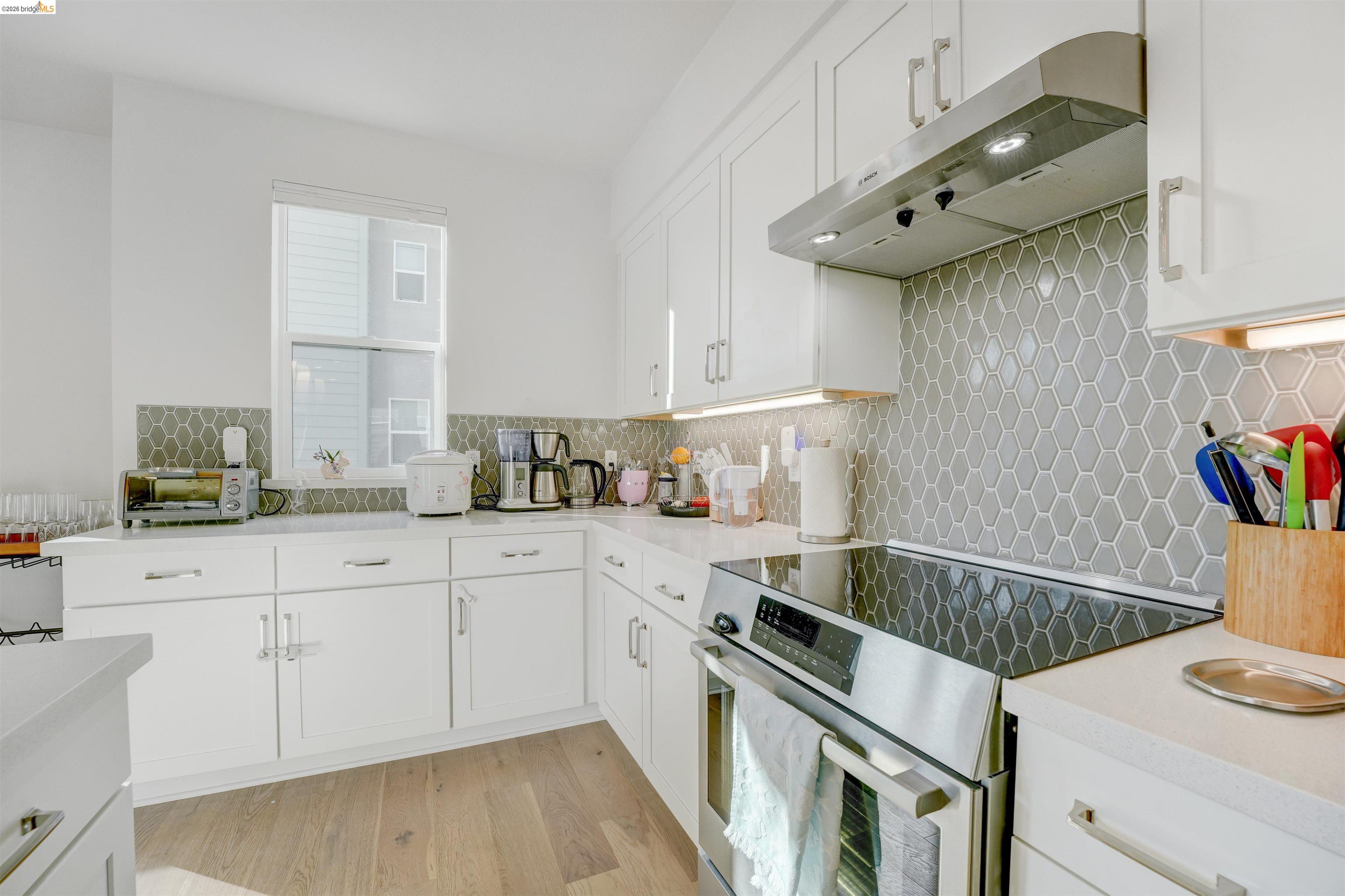7101 Melon Court San Ramon, CA 94583 - Photo 29 of 58 a kitchen with a sink cabinets and wooden floor