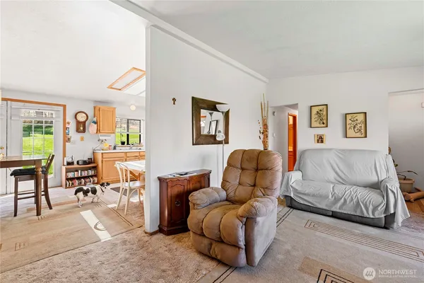 a room with stainless steel appliances kitchen island granite countertop furniture and a dining table