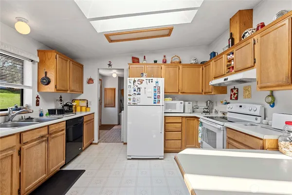 a view of kitchen with sink dining table and chairs
