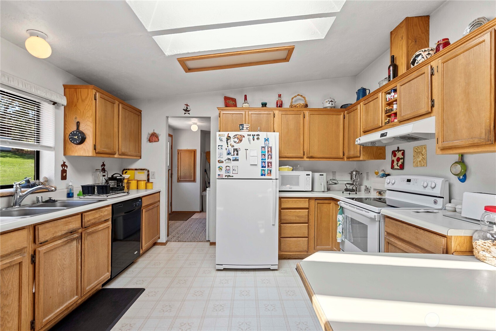 106 Silvest Road Orondo, WA 98843 - Photo 21 of 38 a kitchen with stainless steel appliances granite countertop a refrigerator a stove top oven a sink dishwasher and white cabinets with wooden floor