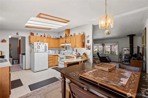 a kitchen with a sink a refrigerator and a window