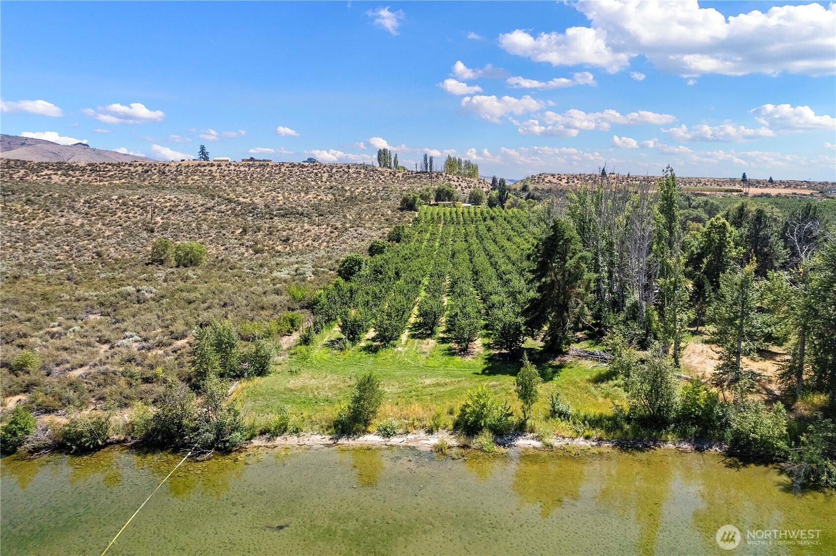 106 Silvest Road Orondo, WA 98843 - Photo 3 of 38 a view of a lake with a building in the background