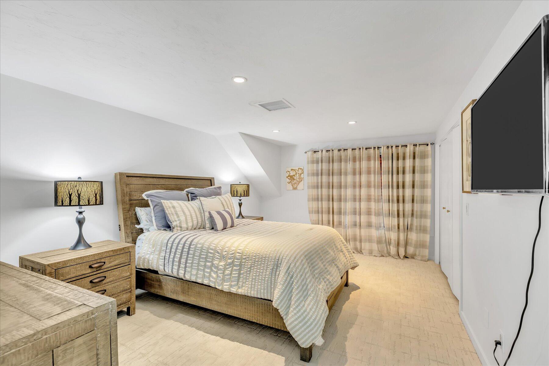 50 Topping Lift Mashpee, MA 02649 - Photo 22 of 34 a bedroom with a bed and a flat screen tv