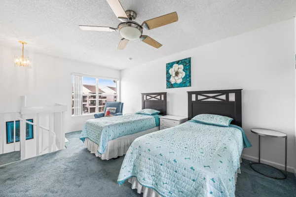 a bedroom with two beds and painting on the wall