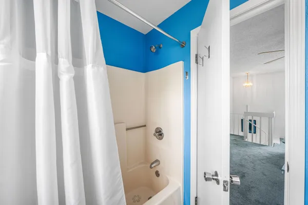 a bathroom with a shower and a tub