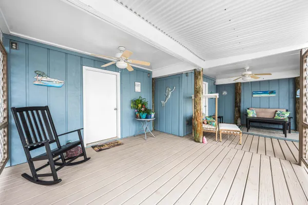 a view of a livingroom with a chair and wooden floor