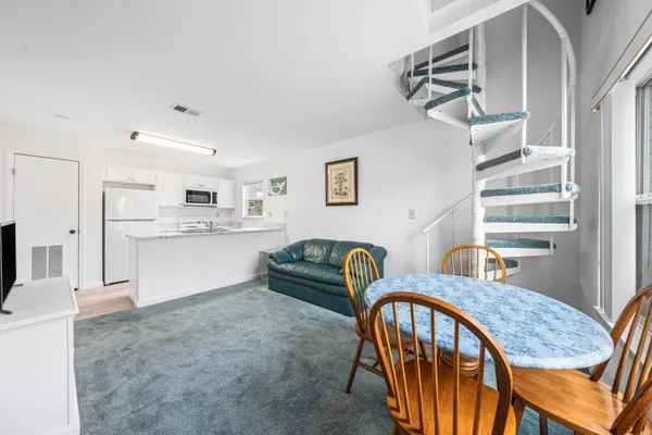 a dining room with furniture and wooden floor