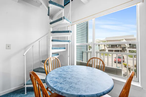 a view of a dining room with furniture and a large window