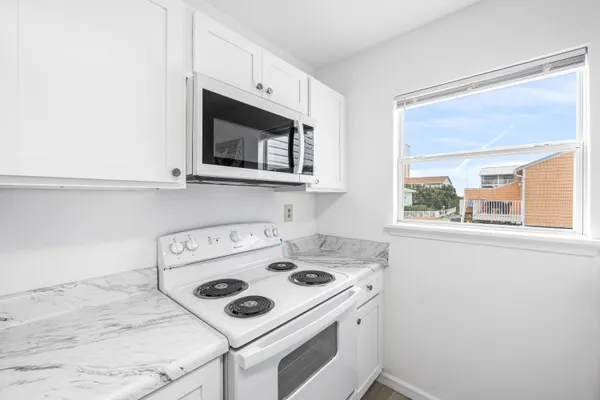 a kitchen with a stove and a microwave