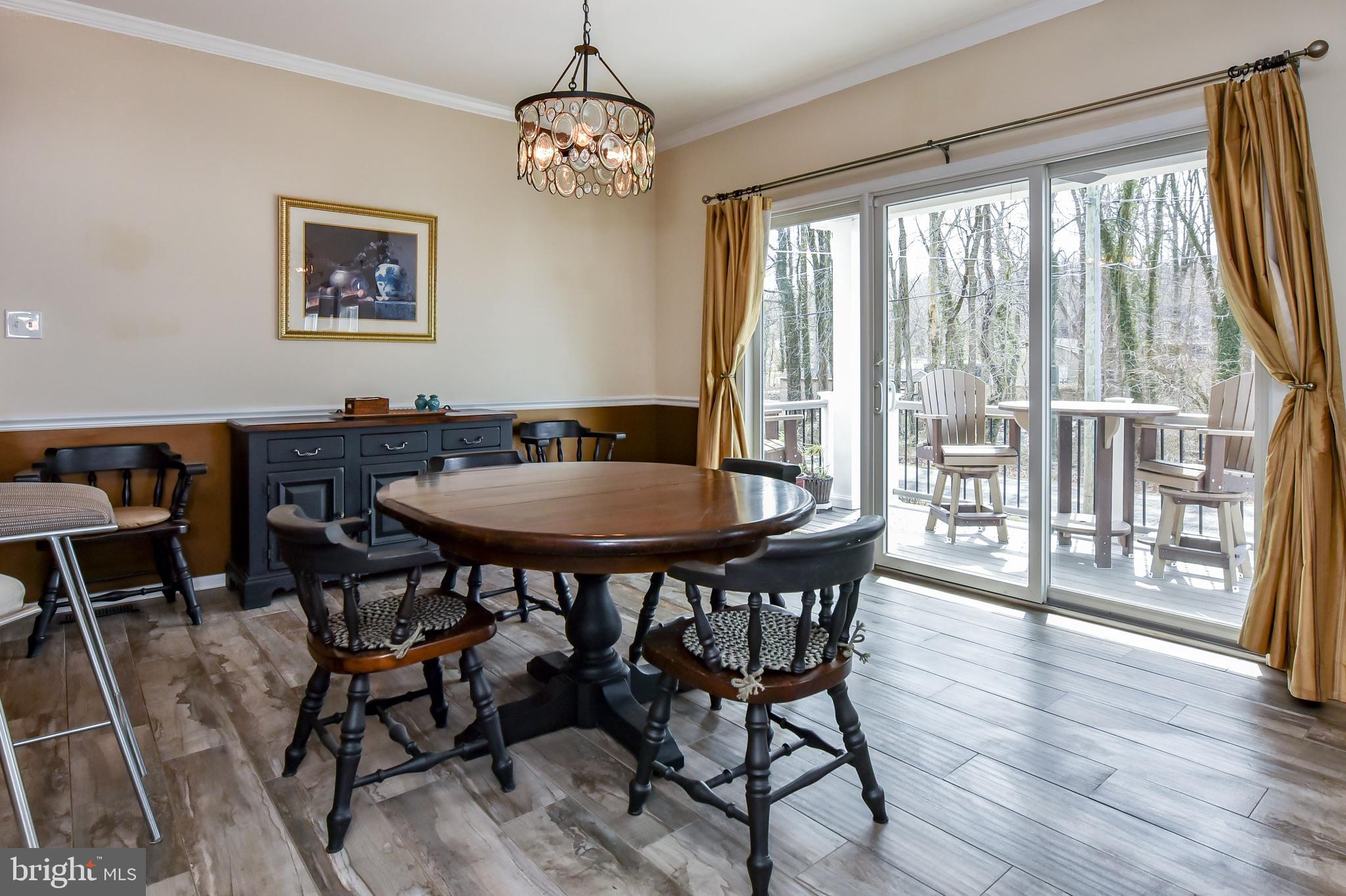 197 Old Locust Point Road Elkton, MD 21921 - Photo 6 of 30 Dining area with sliders to main level deck