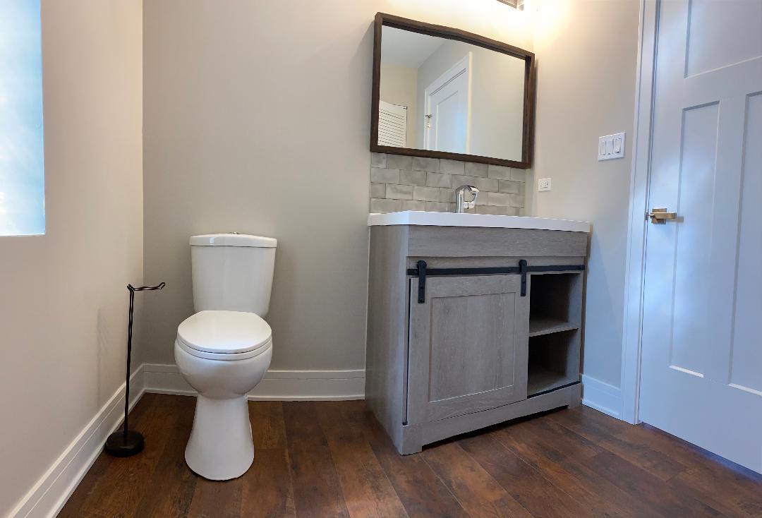 8211 43rd Place Lyons, IL 60534 - Photo 11 of 25 a bathroom with a toilet sink and mirror