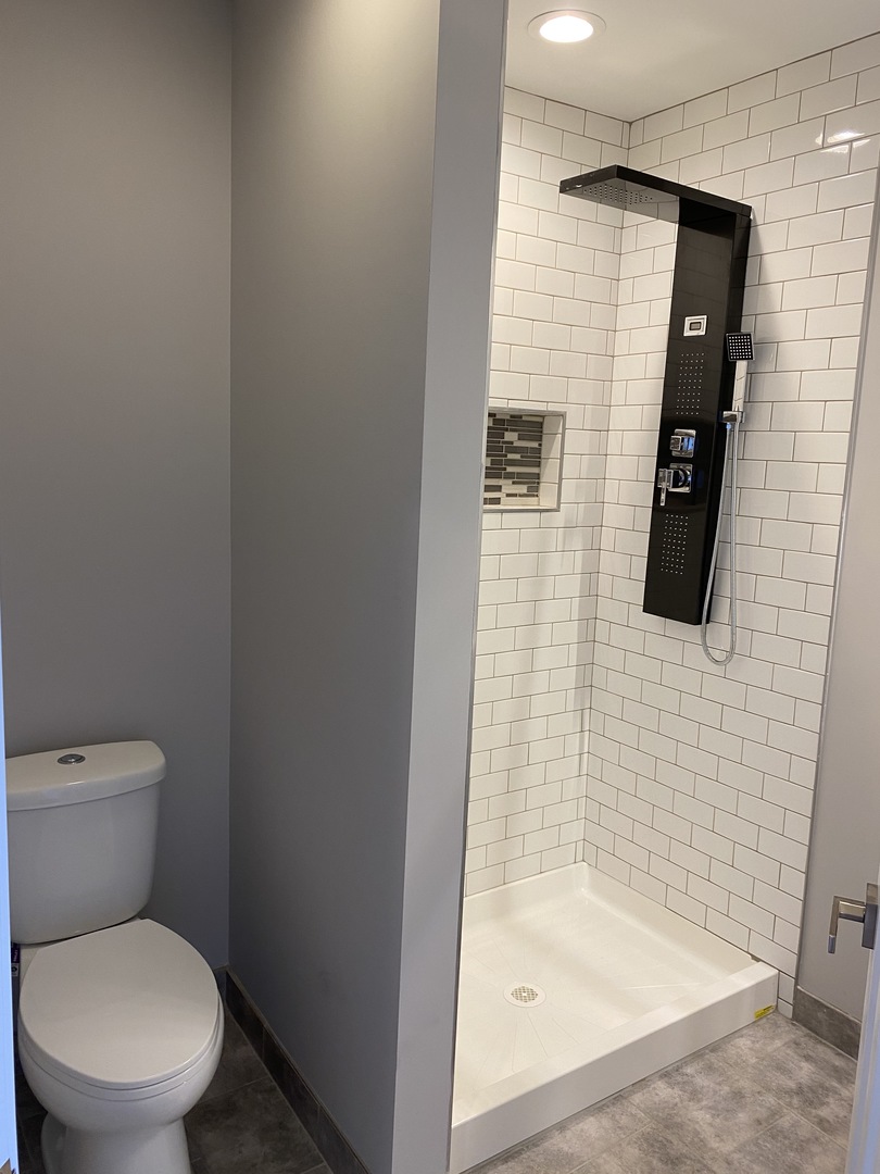 8211 43rd Place Lyons, IL 60534 - Photo 17 of 25 a bathroom with a toilet and a shower