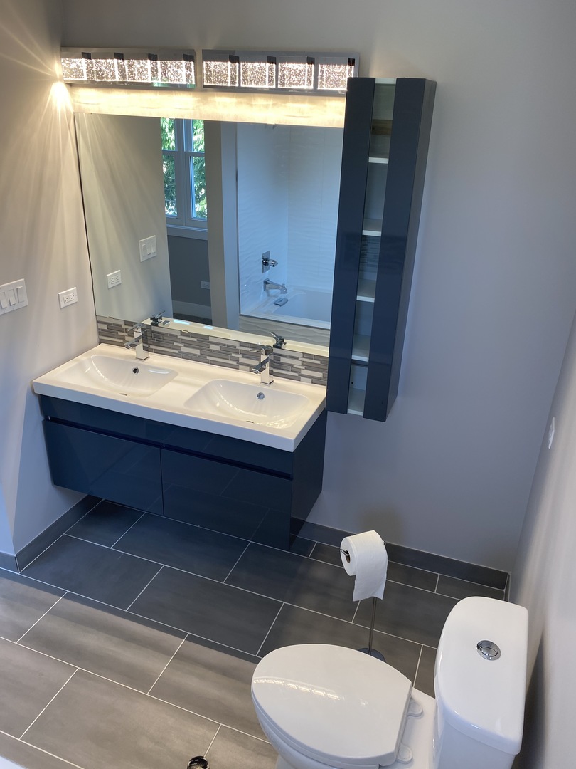 8211 43rd Place Lyons, IL 60534 - Photo 20 of 25 a bathroom with a toilet sink and mirror