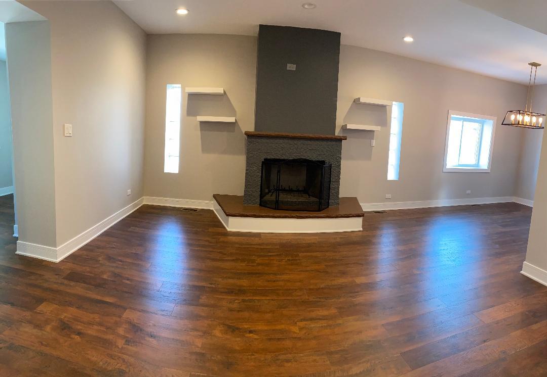 8211 43rd Place Lyons, IL 60534 - Photo 3 of 25 a view of a livingroom with wooden floor and a fireplace
