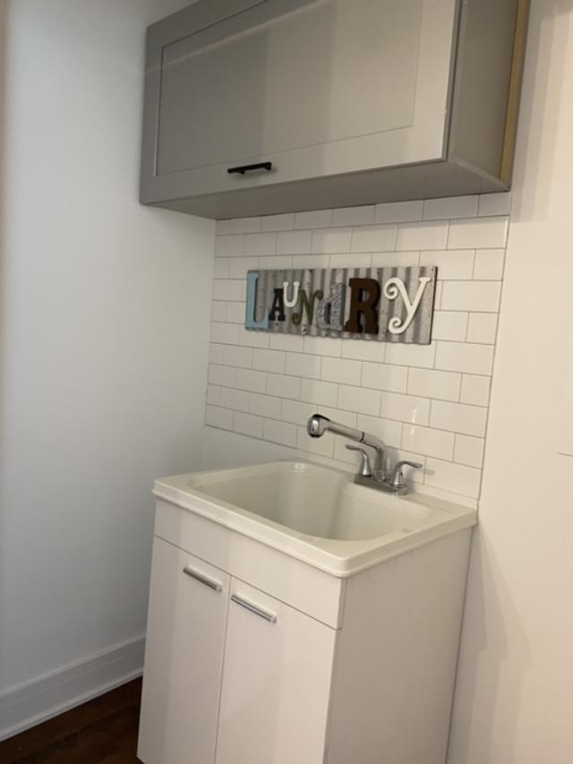 8211 43rd Place Lyons, IL 60534 - Photo 22 of 25 a bathroom with a sink and cabinets