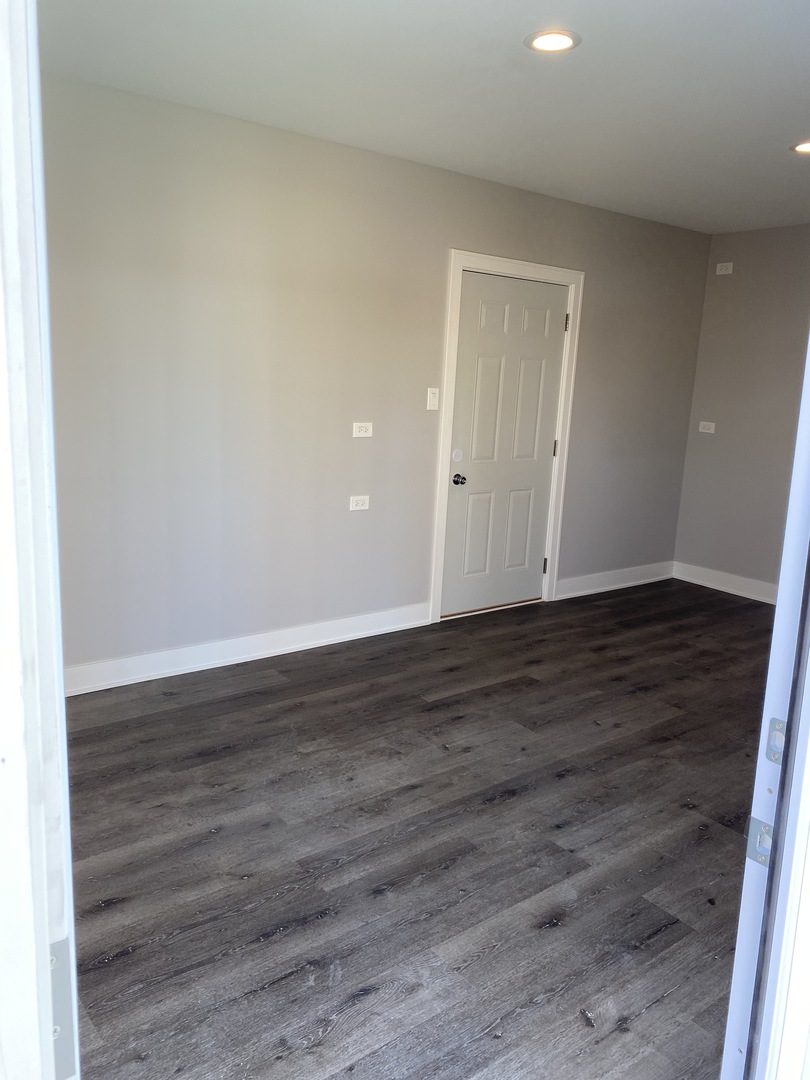 8211 43rd Place Lyons, IL 60534 - Photo 23 of 25 a view of an empty room with wooden floor and entrance