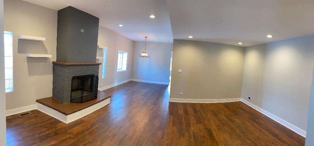 8211 43rd Place Lyons, IL 60534 - Photo 4 of 25 a view of a livingroom with wooden floor and a fireplace