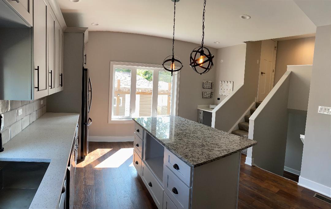 8211 43rd Place Lyons, IL 60534 - Photo 7 of 25 a kitchen view with wooden floor and a chandelier