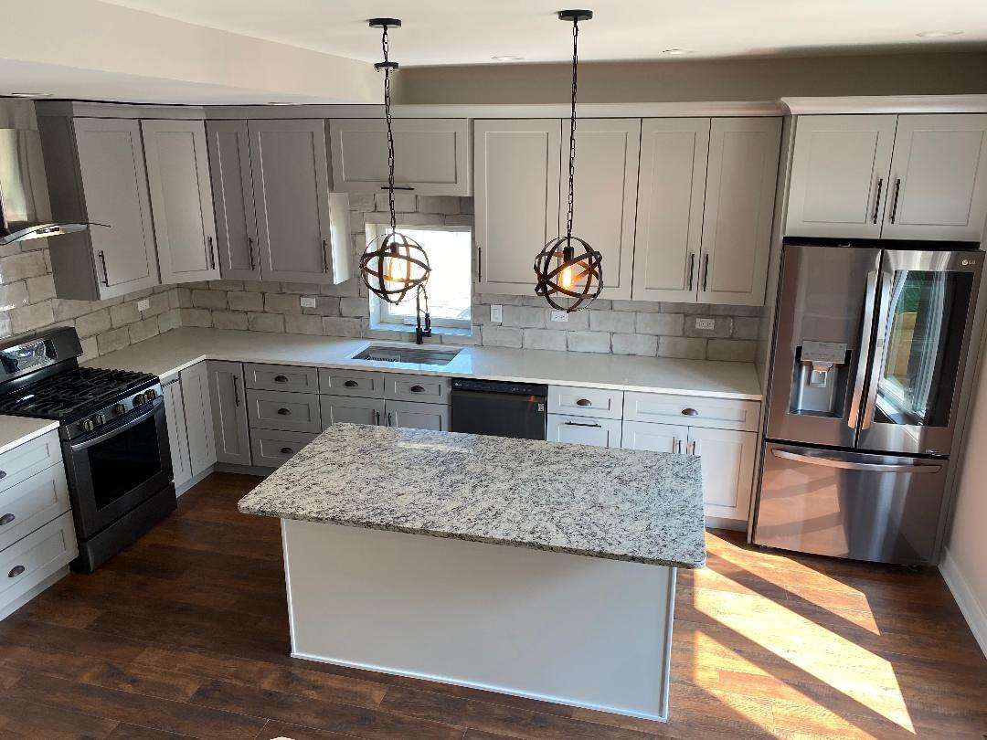 8211 43rd Place Lyons, IL 60534 - Photo 9 of 25 a kitchen with stainless steel appliances granite countertop a sink stove and refrigerator