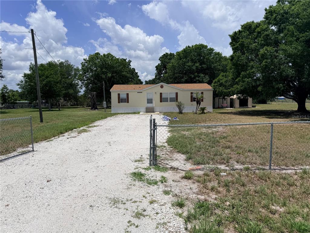33 Ridge Road Frostproof, FL 33843 - Photo 1 of 21 a house that has a tree in front of it