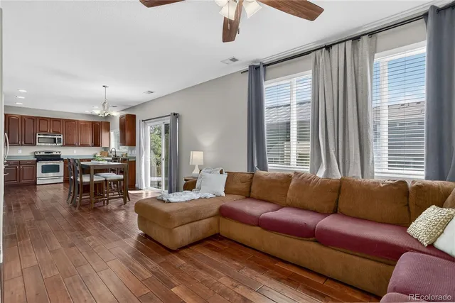 a living room with furniture and wooden floor