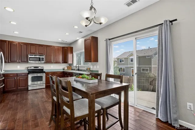 a view of kitchen with granite countertop microwave and cabinets