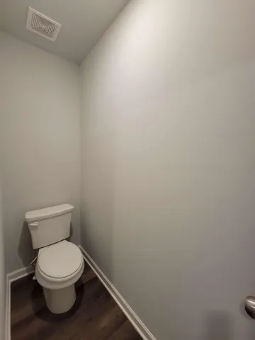 a white toilet sitting next to a white sink