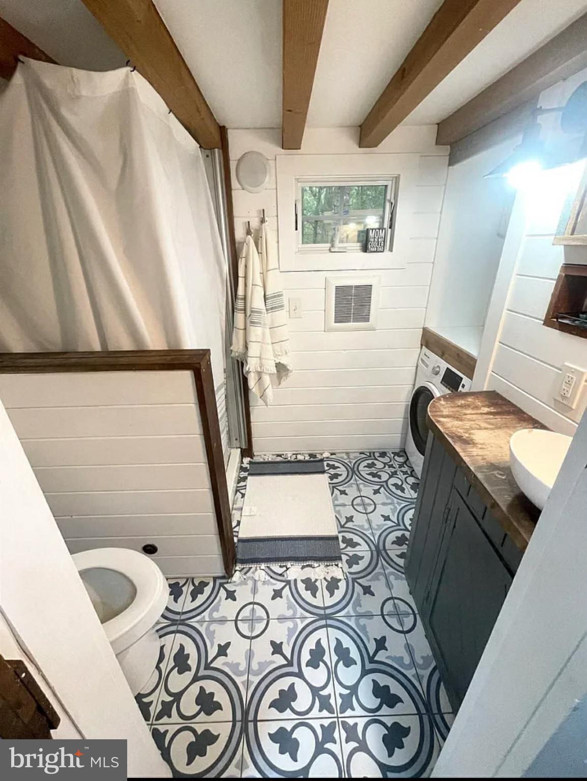 561 Corsons Tavern Road, Unit 43 Ocean View, NJ 08230 - Photo 14 of 18 a bathroom with a sink and mirror with toilet