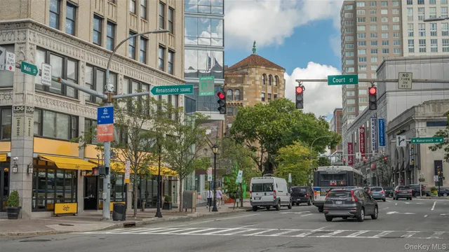 a city street lined with buildings and cars