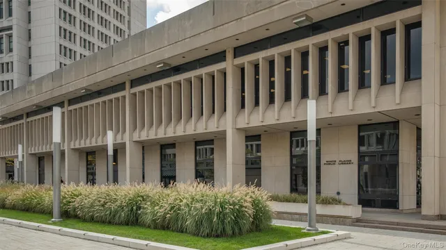a view of a brick house with many windows