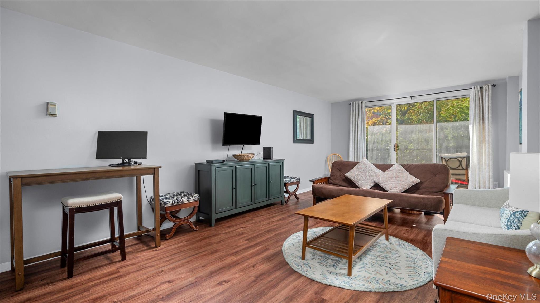 20 Old Mamaroneck Road, Unit 2D White Plains, NY 10605 - Photo 3 of 22 a living room with furniture and a flat screen tv