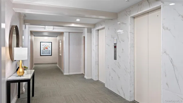 a view of hallway with livingroom and wooden floor