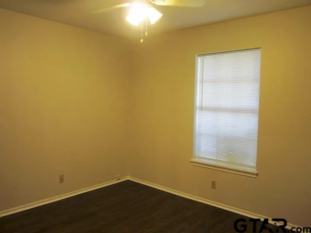a view of a small space with wooden floor and a window
