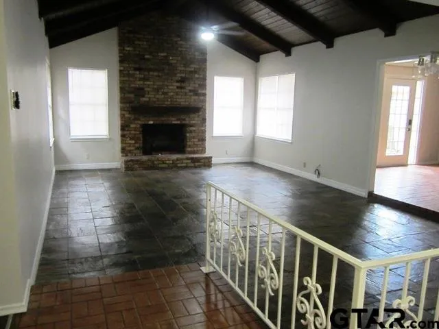 wooden floor in an empty room with a fireplace