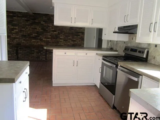 a kitchen with a sink and cabinets