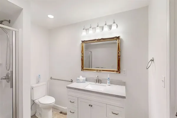 a bathroom with a toilet sink and mirror