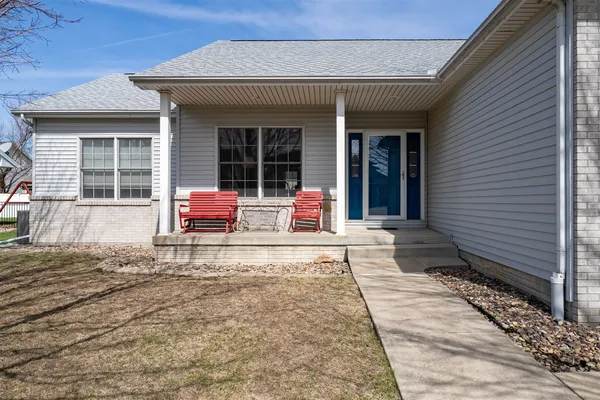 a wooden bench sitting in front of a house