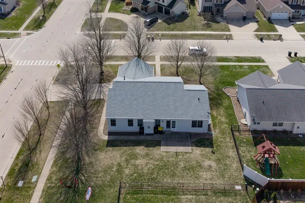 an aerial view of a house with a yard