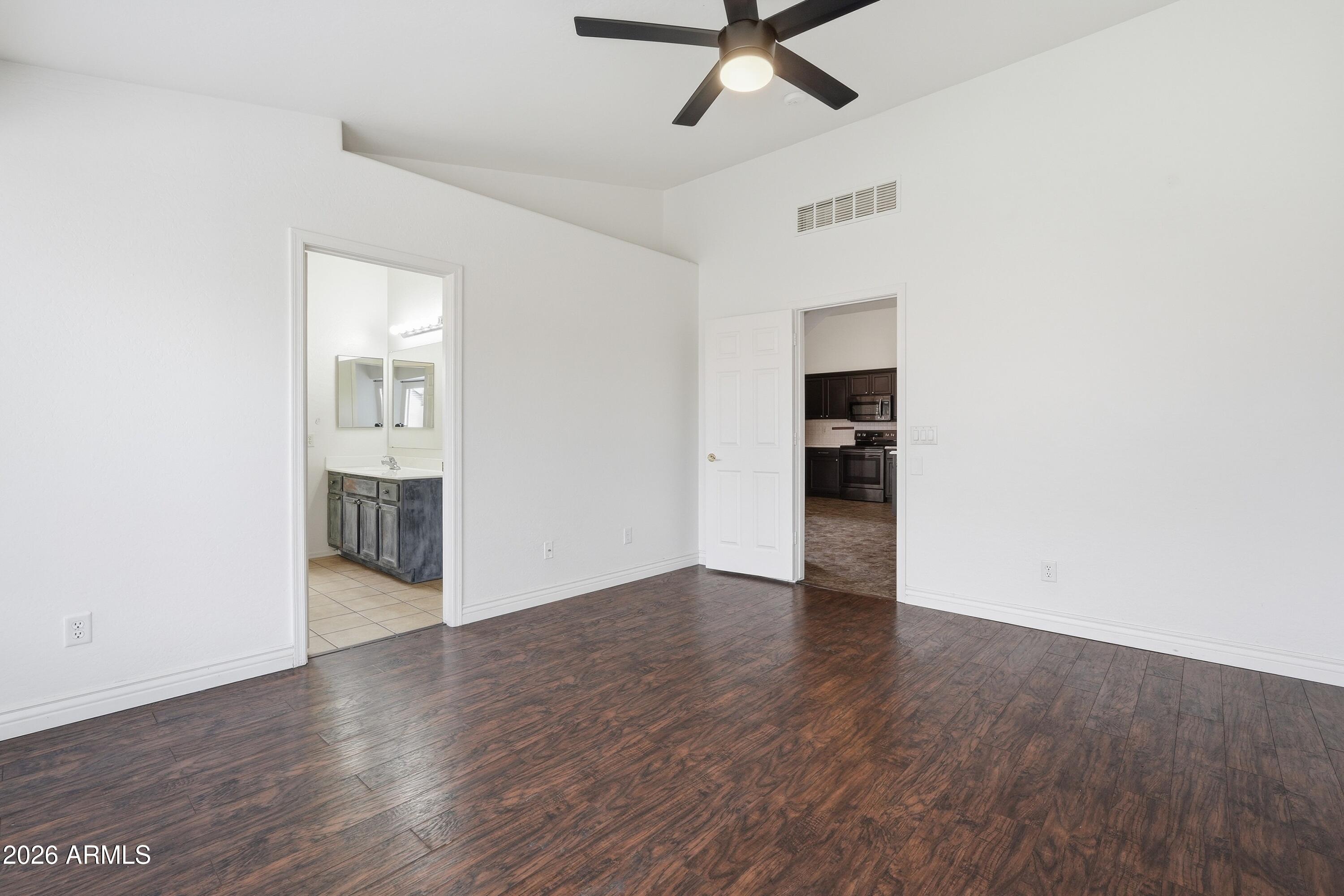 3242 East Bonanza Road Gilbert, AZ 85297 - Photo 15 of 36 a view of a livingroom with wooden floor and a ceiling fan
