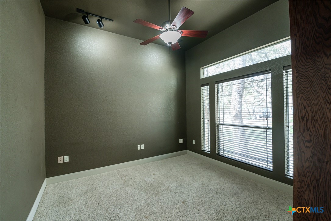 451 Winding View New Braunfels, TX 78132 - Photo 19 of 47 an empty room with ceiling fan and window