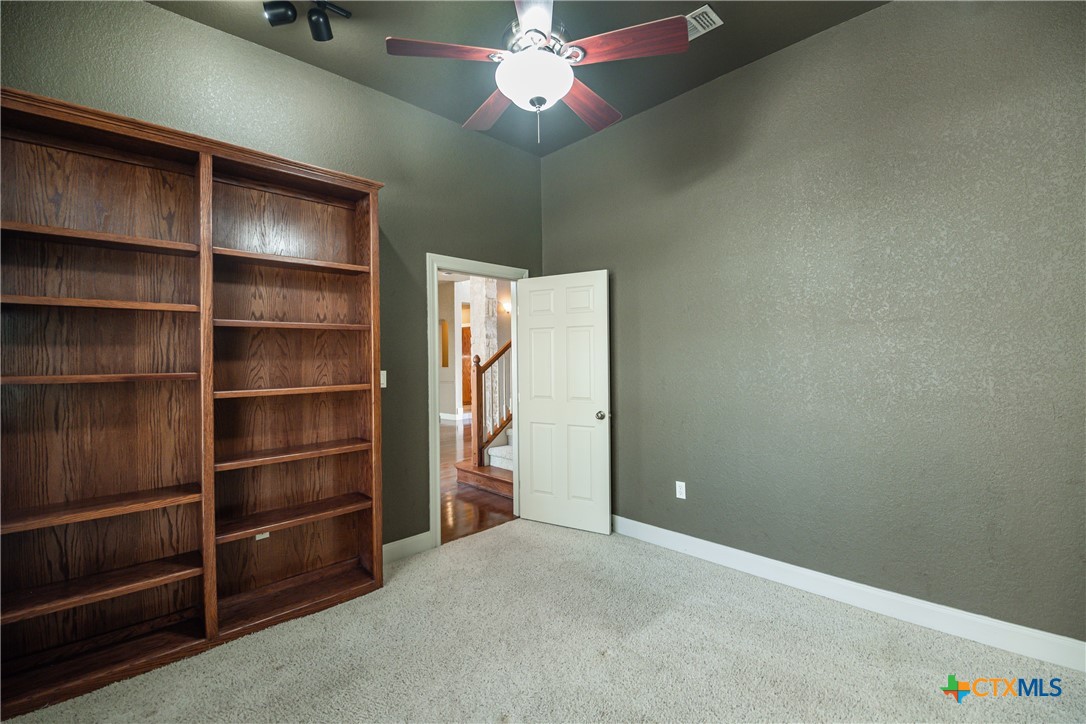 451 Winding View New Braunfels, TX 78132 - Photo 20 of 47 a view of an empty room with a cabinet and a fan