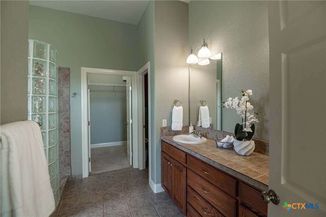 451 Winding View New Braunfels, TX 78132 - Photo 24 of 47 a bathroom with a double vanity sink and a mirror