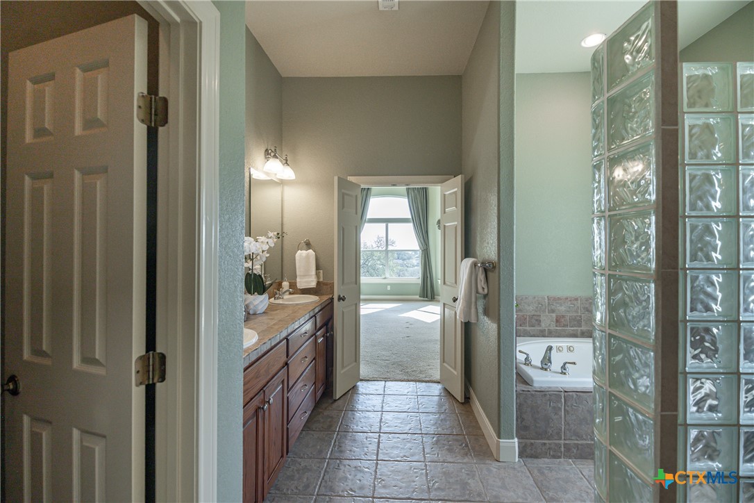 451 Winding View New Braunfels, TX 78132 - Photo 25 of 47 a bathroom with a bathtub and shower