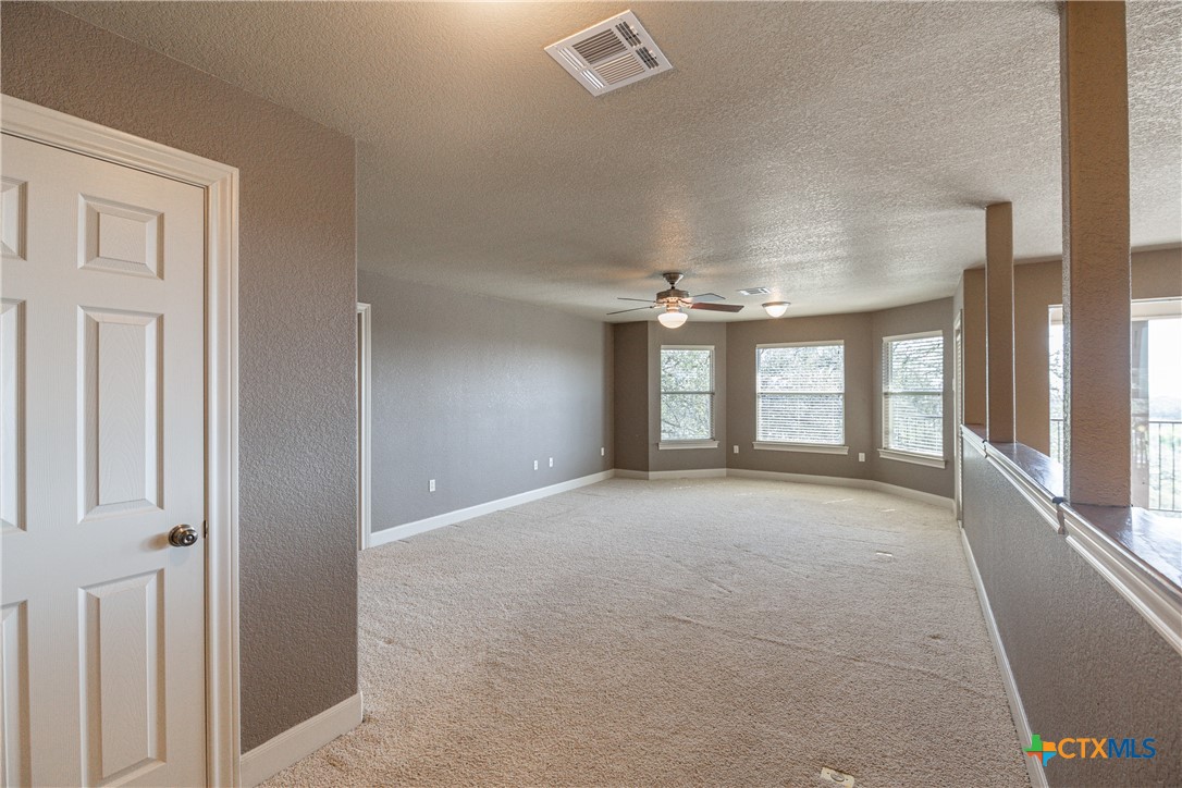 451 Winding View New Braunfels, TX 78132 - Photo 32 of 47 a view of a big room with windows and chandelier