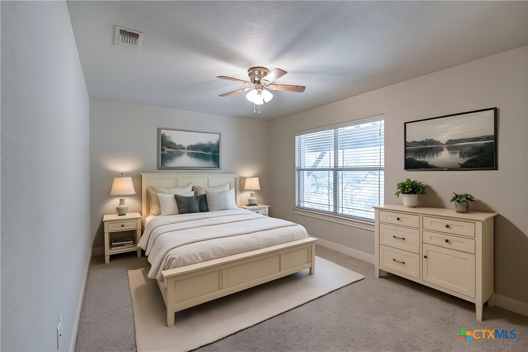 451 Winding View New Braunfels, TX 78132 - Photo 34 of 47 a bedroom with a large bed and a dresser