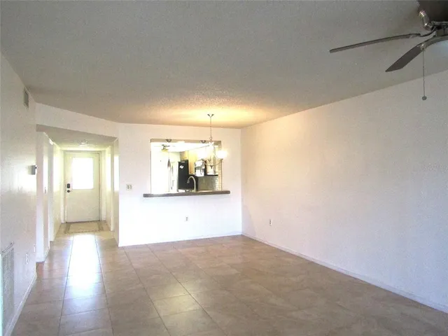 a view of a big room with wooden floor and windows